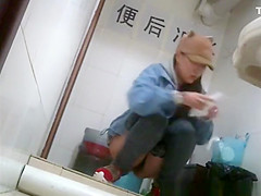Asian girl with funny hat peeing
