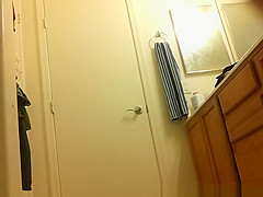 Asian spied dressing in bathroom