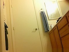 Asian spied dressing in bathroom