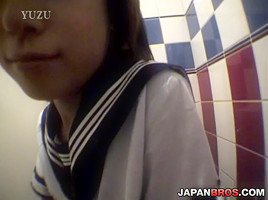 Barely legal Asian in school uniform sucking inside a restroom