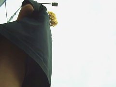 Blonde cutie treats us to an up skirt view of her ass