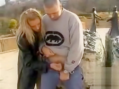 Blonde lady gives a great handjob in public
