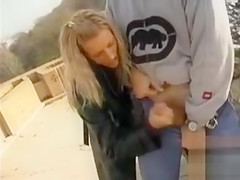 Blonde lady gives a great handjob in public