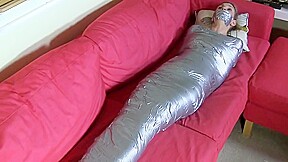 Blonde mummified on sofa