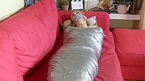 Blonde mummified on sofa
