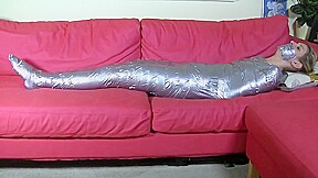 Blonde mummified on sofa