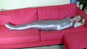 Blonde mummified on sofa