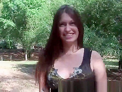 Brunette babe showing off her tits and pussy outdoors
