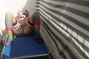 Caged Sissy Plays With Her Dildo On Public Balcony
