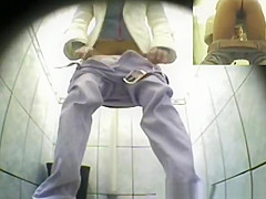 Cute blonde pissing in public toilet