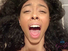 Ebony babe with dark, curly hair and small tits is giving a footjob to her roommate