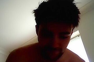 Handsome man is relaxing within doors and shooting himself on web cam