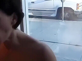Mature woman sucks dick in office with a big window to the street