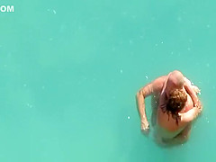 Nude couple fucking in water