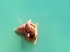 Nude couple fucking in water