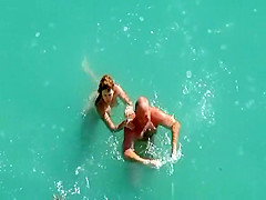 Nude couple fucking in water