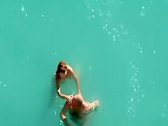 Nude couple fucking in water