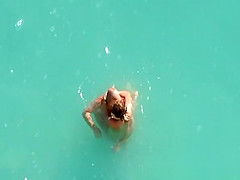 Nude couple fucking in water