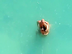 Nude couple fucking in water