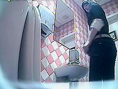 Sexy brunette takes a pee