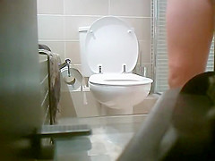 Smooth round butt of a pissing girl