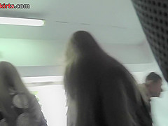 Upskirt shots of auburn-haired gals in a public place