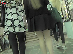 Upskirt shots of auburn-haired gals in a public place